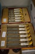 A cased set of six Royal Crown Derby porcelain handled dessert knives and forks (case af).