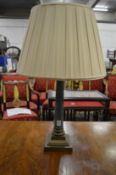 A corinthian column style table lamp.
