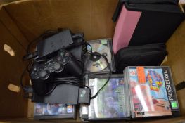 A Sony Playstation 2 together with a controller and numerous games.