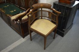 An Edwardian inlaid mahogany corner armchair.