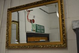 A gilt framed mirror.