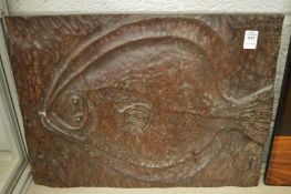 An unusual carved wood plaque depicting a fish.