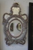 An ornate Venetian style mirror.