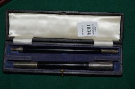 A cased silver mounted two section conductors baton.