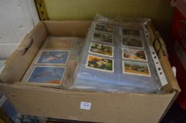 A box of cigarette cards in sleeves.