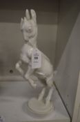 A Continental white porcelain model of a goat standing on its hind legs.