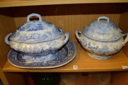 Two blue and white tureens and covers and a willow pattern dish.