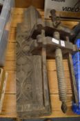 An old wooden carpenters vice and a piece of wood carving.
