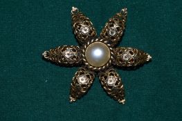 A star shaped brooch signed Sharra Tagano.