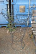 A black painted wire work planter with stand.