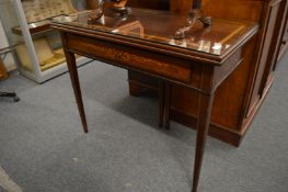 A Continental inlaid mahogany rectangular fold-over tea table with a single drawer on tapering
