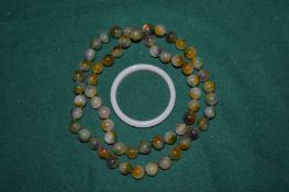 Jade bangle and bead necklace.