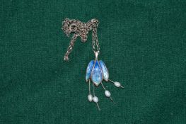 An enamel and silver pendant and chain.