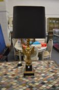 A large ormolu table lamp, the base modelled as an eagle with outswept wings.