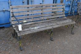 A good large wrought iron and wooden slatted garden bench.
