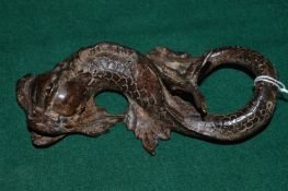 A patinated cast bronze model of a dolphin in a Renaissance style.