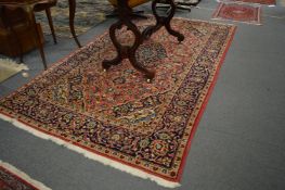 A good Persian design carpet, pink ground with floral decoration, 252cm x 146cm.