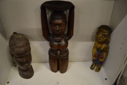 Three carved wood African figures.