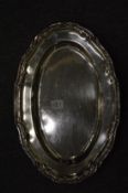 A white metal oval dish with decorative border, stamped 925.