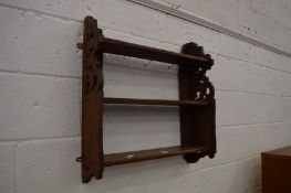 A set of walnut wall shelves.