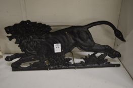 Cast metal plaque depicting a male lion.
