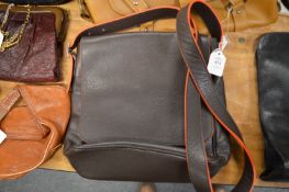 A brown leather messenger bag.