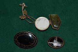 Three decorative brooches.