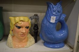A blue glazed gluggle jug together with a Doulton character jug May West.