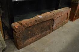 A pair of terracotta plaques.