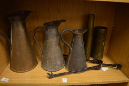 A graduated set of three copper jugs and other items.