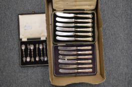 Two cased sets of silver handled butter knives and a cased set of Eastern white metal coffee