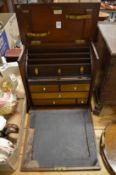 A mahogany table top stationery cabinet.