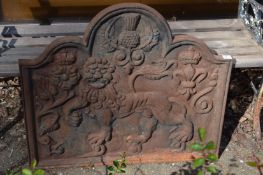 Cast iron fireback decorated with a lion and other motifs.