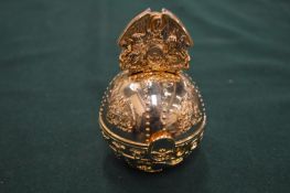 An unusual gilt orb shaped memory stick holder.