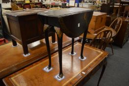 A chinoiserie decorated ebonised drop-flap occasional table.
