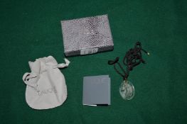 A Lalique engraved glass pendant with cord necklace.