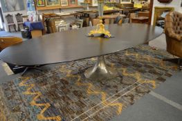 Julian Chichester, a Dakota oval shaped dining table, ebonised oak supported on a polished nickel