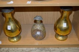 A pair of brass vases and a Dimple bottle.