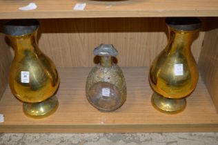 A pair of brass vases and a Dimple bottle.