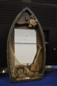 A novelty mirror modelled as a sailing dingy.