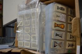A box of cigarette cards in sleeves.