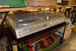 A Toshiba stereo music centre on a glass and chrome stand.