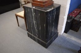A faux marble pedestal.