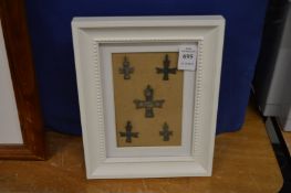 A group of bronze crosses, framed and glazed.