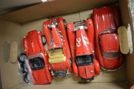 Four die-cast model cars.