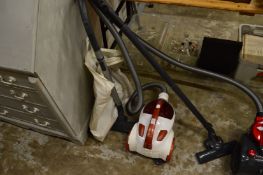 A Hoover compact vacuum cleaner with accessories.