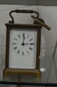 A small brass carriage clock.