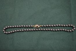 A bead necklace with silver clasp.