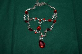 Decorative necklace mounted with red stones.