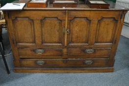 An 18th century oak cupboard with drawers.